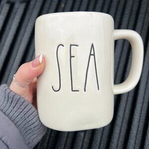 Rae Dunn white coffee mug with black writing "Sea"